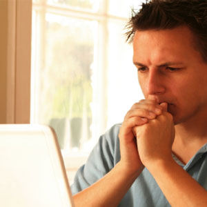 young stressed man sitting at home