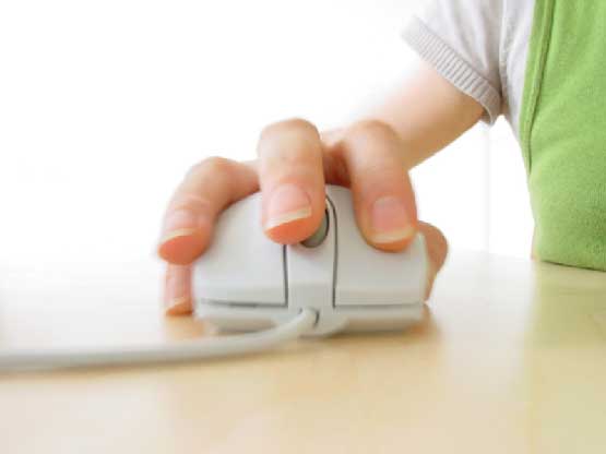 Girl using a mouse of a computer