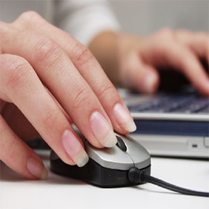Woman using a mouse and a computer
