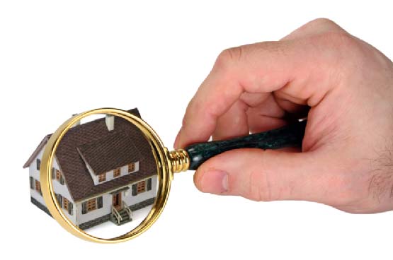 Man holding Magnifying glass on house